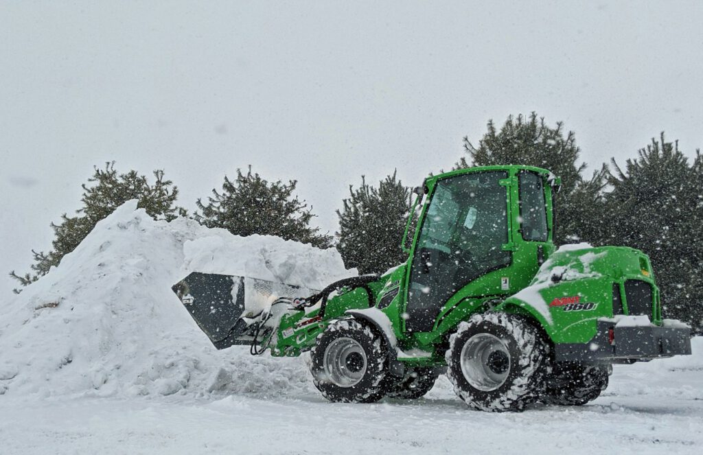 green and black atv on snow covered ground